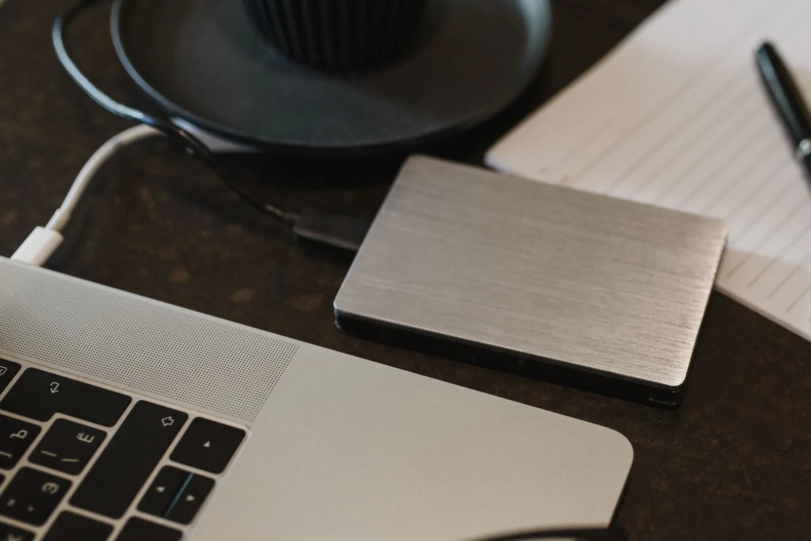 External drive connected to a laptop for a controlled media backup workflow