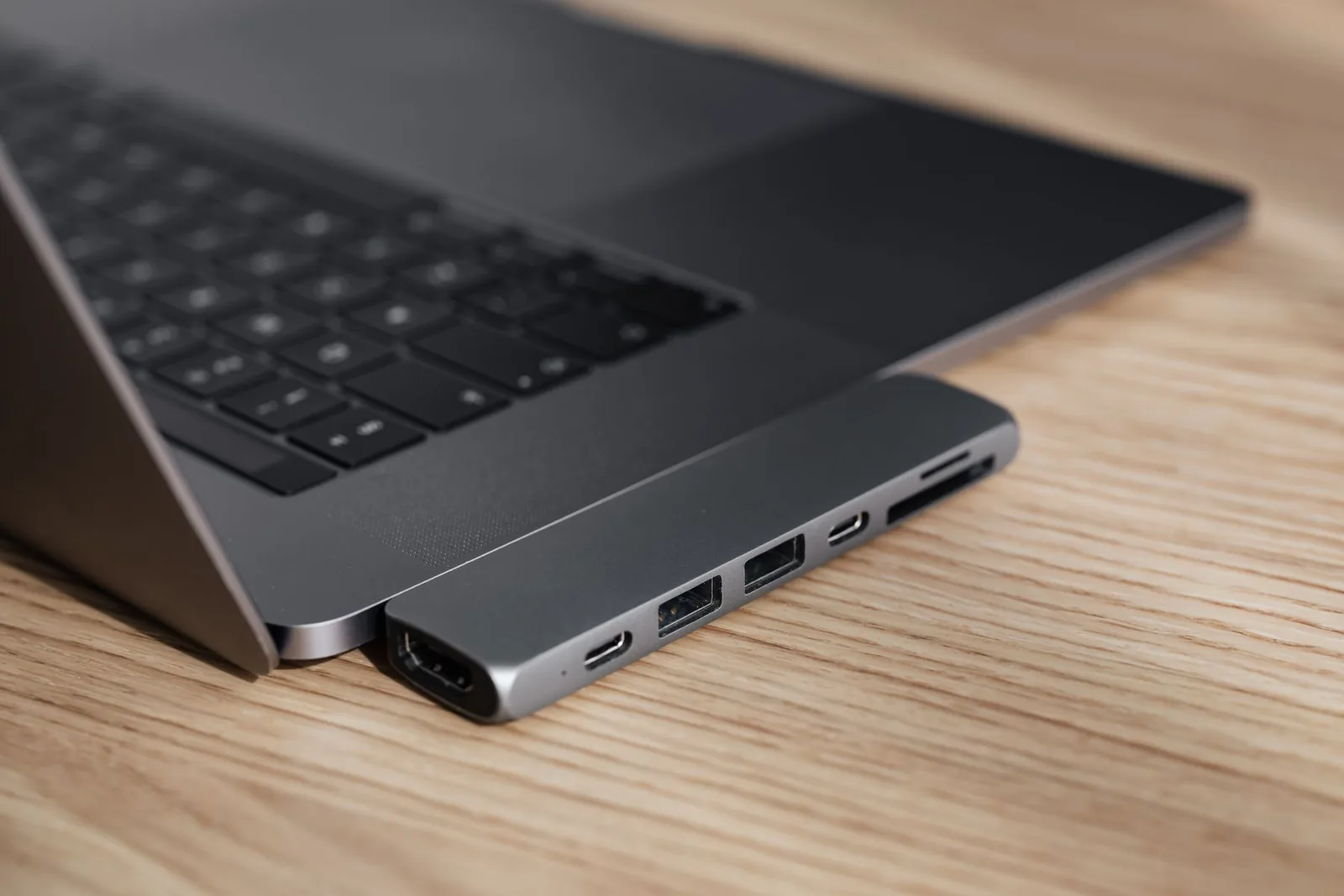Laptop with a connected USB hub illustrating a managed connected media workflow